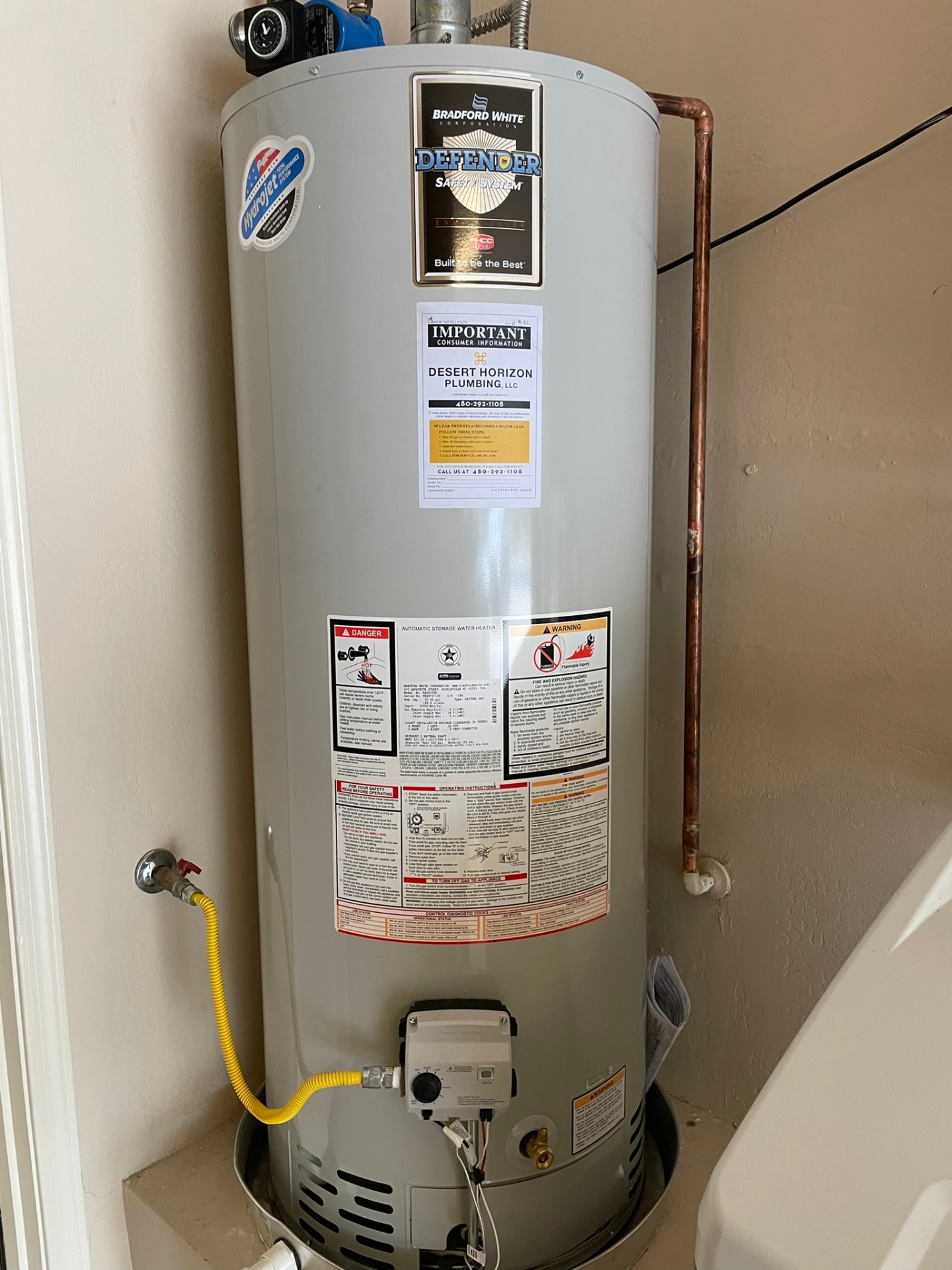Plumber draining sediment from a water heater